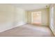 Spacious carpeted living room with natural light and open doorway, offering versatility and comfort at 763 Brookwood Sw Ter, Lilburn, GA 30047