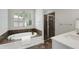 Bright bathroom with a tub, shower, and vanity with marble countertop at 1020 Austin Ne Ave, Atlanta, GA 30307