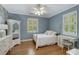 Well-lit bedroom featuring white furniture, hardwood floors, and a window with shutters at 1020 Austin Ne Ave, Atlanta, GA 30307