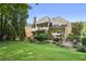 Well-maintained backyard featuring a lush lawn, patio, and mature trees at 4874 Registry Nw Ln, Kennesaw, GA 30152