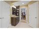 Bright bathroom featuring a granite-topped vanity and access to a walk-in closet at 4874 Registry Nw Ln, Kennesaw, GA 30152