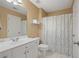 Clean bathroom features a vanity and a shower with patterned curtain at 4874 Registry Nw Ln, Kennesaw, GA 30152