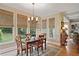 Bright dining room with three large windows, chandelier, and wood table at 4874 Registry Nw Ln, Kennesaw, GA 30152