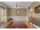 Formal dining room featuring hardwood floors, decorative chandelier, and wainscoting at 4874 Registry Nw Ln, Kennesaw, GA 30152