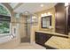 Well-lit main bathroom with granite counters, a glass shower, and a luxurious soaking tub under a window at 4874 Registry Nw Ln, Kennesaw, GA 30152