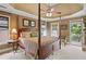Spacious main bedroom featuring a four-poster bed, tray ceiling, and private access to an outdoor balcony at 4874 Registry Nw Ln, Kennesaw, GA 30152