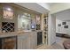 Stylish wet bar area complete with custom cabinets, wine storage, and a mini fridge at 4874 Registry Nw Ln, Kennesaw, GA 30152