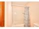 Simple bathroom features a shower and tub combo with neutral finishes, with a curtain for privacy at 1123 Willow Trce, Grayson, GA 30017
