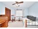 Cozy bedroom features ample natural light, a ceiling fan, and a large closet at 1123 Willow Trce, Grayson, GA 30017