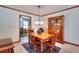 Cozy dining room with a wooden table, chairs, and a view into another room at 1123 Willow Trce, Grayson, GA 30017