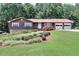 Charming single-story home boasts a well-manicured lawn, mature trees, and a two-car garage at 1123 Willow Trce, Grayson, GA 30017