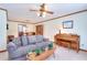 Bright living room adjacent to the dining room, featuring a piano and comfortable seating at 1123 Willow Trce, Grayson, GA 30017