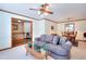 Living room featuring stairs to second level, a view into the dining room, and comfortable seating at 1123 Willow Trce, Grayson, GA 30017