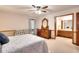 Bedroom showcasing a dresser, an ensuite bathroom, and neutral-colored walls at 1123 Willow Trce, Grayson, GA 30017