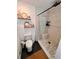 Bathroom featuring black fixtures and a shower featuring a chevron pattern floor and marble patterned shower walls at 124 Dockside Downs Dr, Woodstock, GA 30189