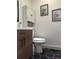Side angle of a charming bathroom with hexagon tile and white cabinet at 124 Dockside Downs Dr, Woodstock, GA 30189
