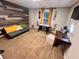 Bedroom space with wood accent wall, desk with natural light, and a stylish daybed at 124 Dockside Downs Dr, Woodstock, GA 30189