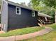 Exterior view showcasing the home's architecture, backyard and surrounding greenery at 124 Dockside Downs Dr, Woodstock, GA 30189