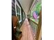Inviting porch featuring a patriotic American flag and ornamental plants on wood flooring at 124 Dockside Downs Dr, Woodstock, GA 30189