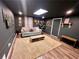 Cozy living room featuring hardwood floors, plush carpet, and dark accent walls and trim at 124 Dockside Downs Dr, Woodstock, GA 30189