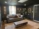 Cozy living room with a comfortable couch, plush carpet, and dark accent walls at 124 Dockside Downs Dr, Woodstock, GA 30189