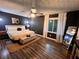 Modern bedroom featuring hardwood floors, a large bed, and stylish decor at 124 Dockside Downs Dr, Woodstock, GA 30189