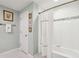 Bathroom features a tiled shower and tub combination with white tile and decorative accents at 1600 Belle Isle Ne Cir, Atlanta, GA 30329