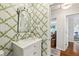 Powder room featuring patterned wallpaper, a pedestal sink, and stylish fixtures and finishes at 1600 Belle Isle Ne Cir, Atlanta, GA 30329