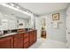 Well lit bathroom showcasing a double sink vanity with dark countertops and a decorative mirror at 1600 Belle Isle Ne Cir, Atlanta, GA 30329