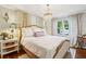 Main bedroom with a chandelier, bedside tables and hardwood floors at 1600 Belle Isle Ne Cir, Atlanta, GA 30329