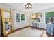 Bright bedroom with wooden floors, a desk, and large windows overlooking lush greenery at 1600 Belle Isle Ne Cir, Atlanta, GA 30329