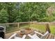 Relax on the wooden deck with string lights, overlooking the lush green backyard at 1600 Belle Isle Ne Cir, Atlanta, GA 30329