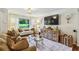 Well-lit living room featuring a comfortable seating area, elegant decor, and a large screen TV at 1600 Belle Isle Ne Cir, Atlanta, GA 30329