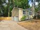 View of the side of the house featuring a two car garage, neutral siding, and manicured landscaping at 2489 Smith Ave, Marietta, GA 30064
