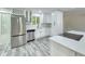 Beautiful kitchen featuring stainless steel appliances, white cabinetry, stone countertops, and modern flooring at 2489 Smith Ave, Marietta, GA 30064