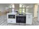 Open-concept kitchen featuring a stainless steel oven and microwave nestled in a kitchen island with a stone countertop at 2489 Smith Ave, Marietta, GA 30064