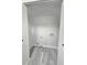 Well-lit laundry room with white shelving and hook ups at 2489 Smith Ave, Marietta, GA 30064