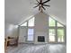 Bright living room with soaring ceilings, a fireplace, and many windows overlooking the outside landscape at 2489 Smith Ave, Marietta, GA 30064