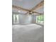 Spacious bedroom featuring a ceiling fan, wood beams and an abundance of natural light through multiple windows at 2489 Smith Ave, Marietta, GA 30064
