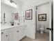 Bright bathroom with a double sink vanity, and view of shower and toilet room at 635 Opera Ln, Alpharetta, GA 30009