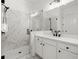 Modern bathroom features sleek glass shower doors, marble tile walls and floor, and dual vanity sinks at 635 Opera Ln, Alpharetta, GA 30009