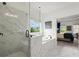 Bright bathroom featuring a glass enclosed shower and separate soaking tub with white marble tiling throughout at 635 Opera Ln, Alpharetta, GA 30009