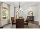 Charming dining room with a stylish chandelier, natural light, and a cozy atmosphere at 635 Opera Ln, Alpharetta, GA 30009