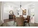 Open dining room featuring stylish lighting, neutral decor, and easy access to other living spaces at 635 Opera Ln, Alpharetta, GA 30009