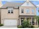 Charming two-story home featuring a brick facade, inviting porch, and a well-manicured front yard at 635 Opera Ln, Alpharetta, GA 30009