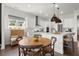 Eat-in kitchen features stainless appliances, stylish island, breakfast table and cozy window seat at 635 Opera Ln, Alpharetta, GA 30009