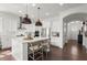 Modern kitchen with white cabinetry, a large center island, and stainless steel appliances at 635 Opera Ln, Alpharetta, GA 30009