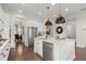 Bright kitchen with stainless steel appliances, island with sink and seating, and stylish pendant lighting at 635 Opera Ln, Alpharetta, GA 30009