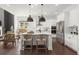 Spacious kitchen with an island, modern appliances, and an adjacent dining area, perfect for entertaining at 635 Opera Ln, Alpharetta, GA 30009