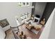 Spacious living room boasts tall windows, fireplace, hardwood floors, and stylish modern decor at 635 Opera Ln, Alpharetta, GA 30009